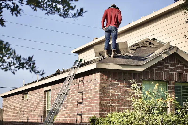Professional roofer working on a residential roof in Montopolis
